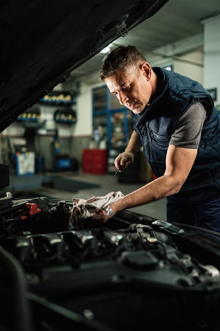 Firestone Buckner auto mechanic inspecting engine, reliable automotive repair services
