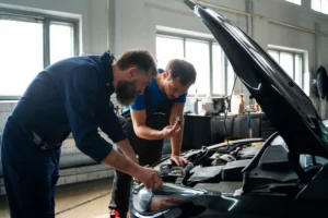 Firestone Buckner mechanics working on a car engine, automotive maintenance and repair.